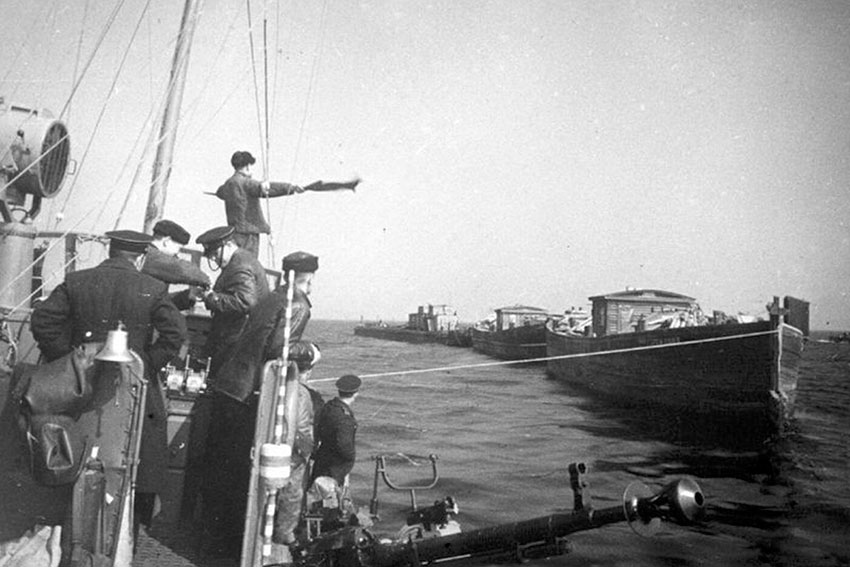 Малый охотник типа МО-4 буксирует баржи с продовольствием...